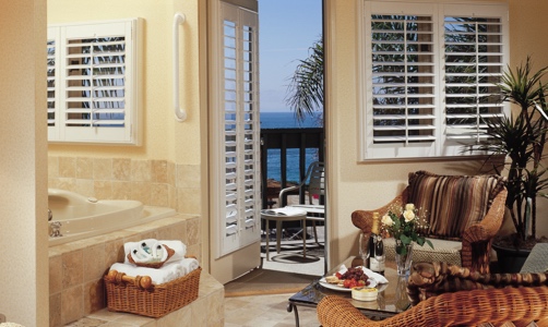 Plantation shutters on casement windows in a tropical home.
